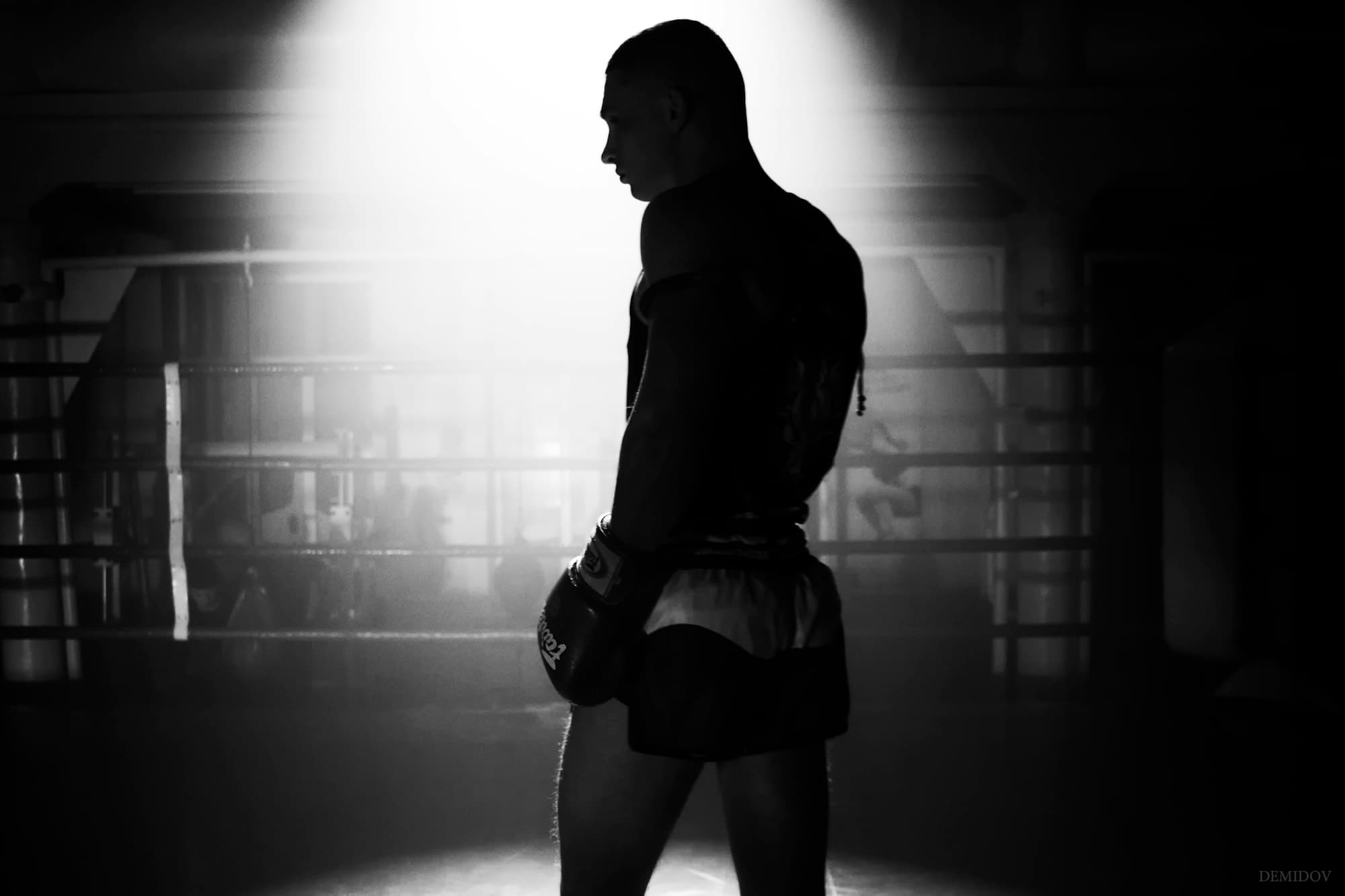 Athlete in a hooded sweatshirt between sets