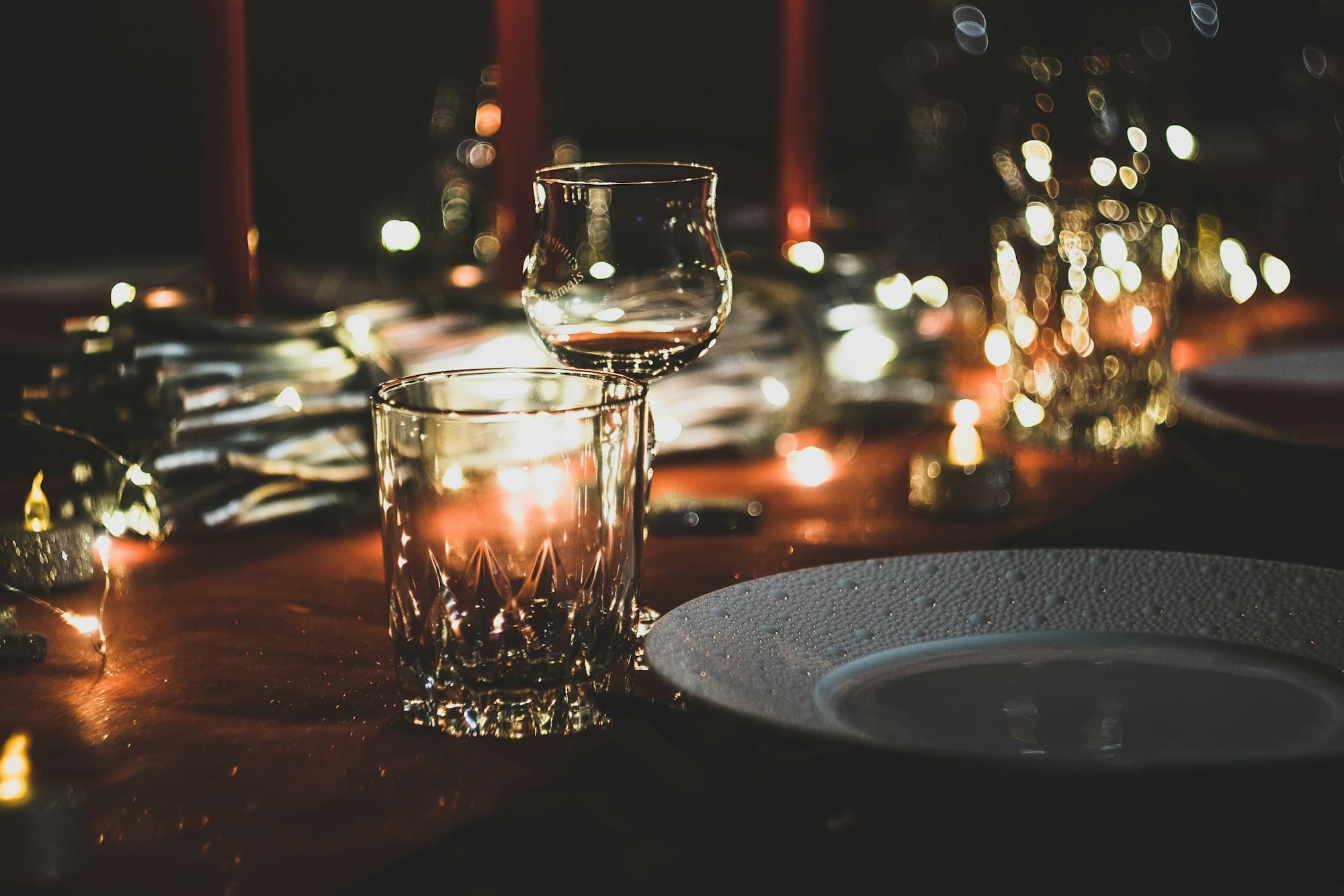 Candlelight and glassware at an evening celebration